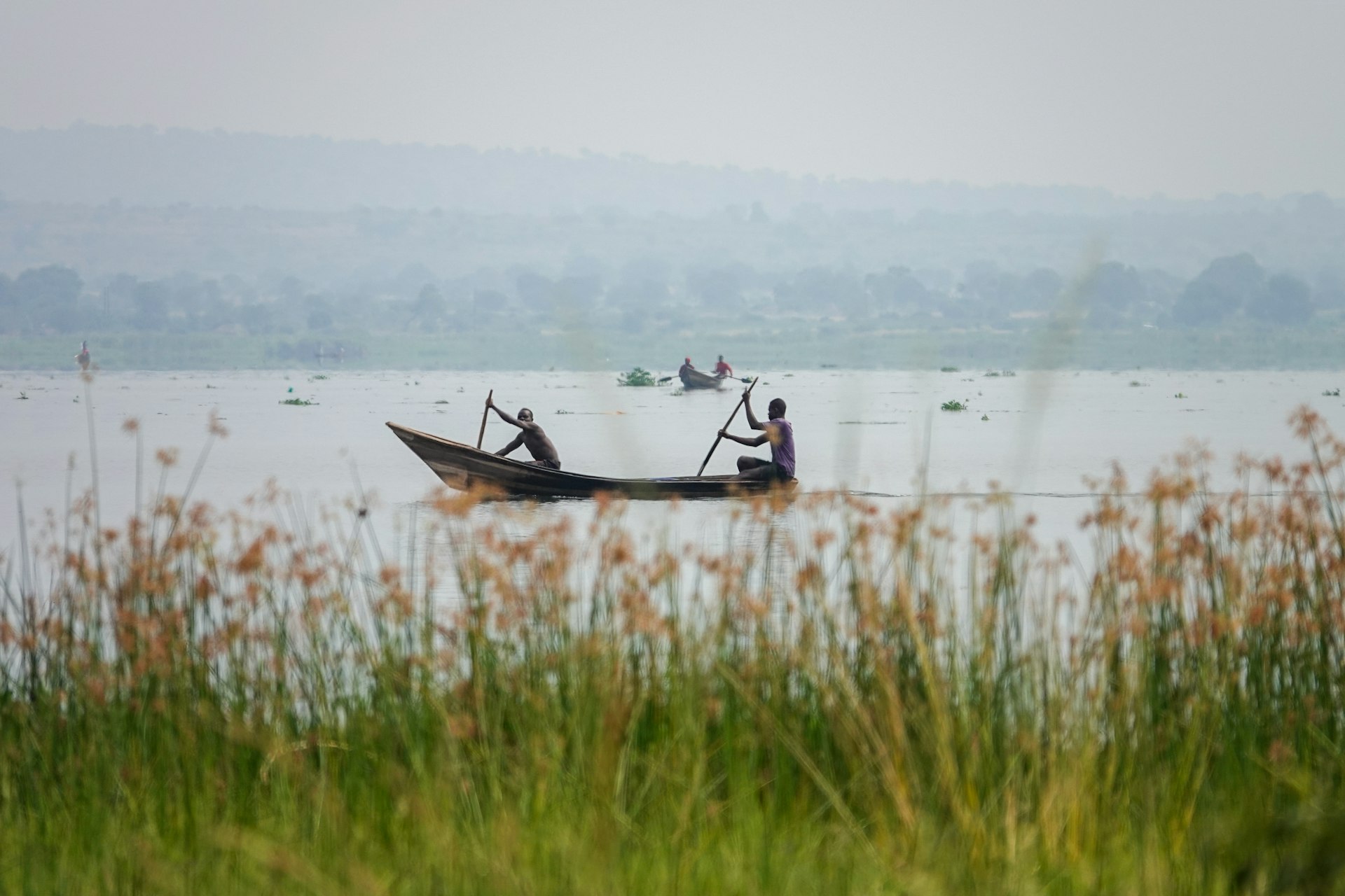 Two people in a small boat on a large body of water